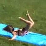 Child face-planting on a slip-n-slide